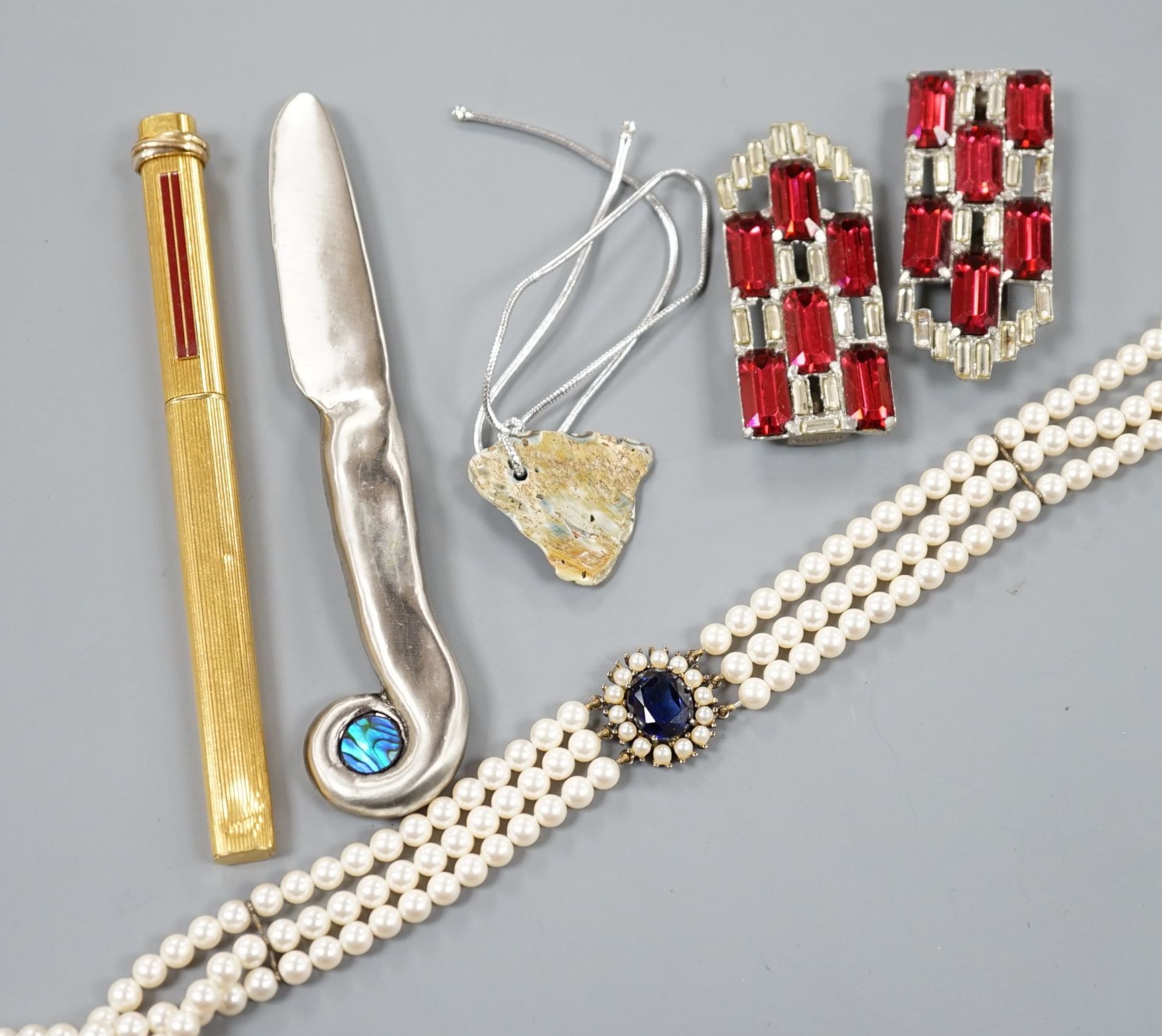 A Cartier gold plated end red enamel ball point pen and minor costume jewellery.